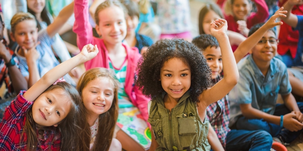 Diversegroupofchildrensmilingandraisinghandshappykids - Rick's Blog