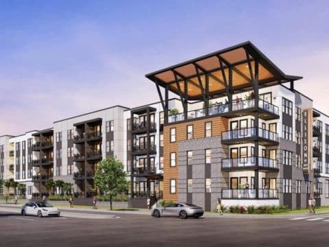 Modern multi?story apartment building with glass balconies and a large corner terrace.