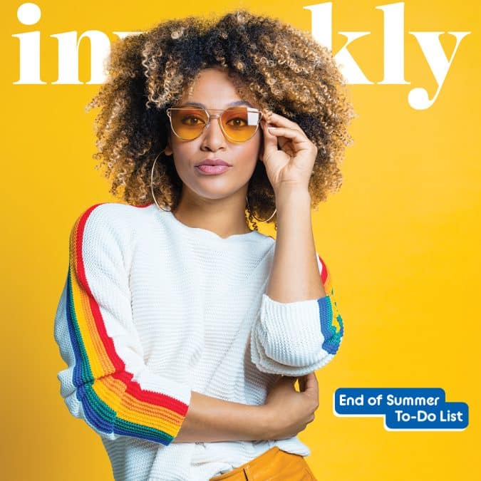Portrait of a woman with curly hair in a white sweater with rainbow sleeves, yellow background, wearing orange sunglasses, on a magazine cover