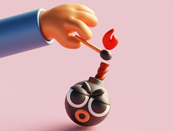 Cartoon hand lighting a fuse on a round bomb with a pink background.