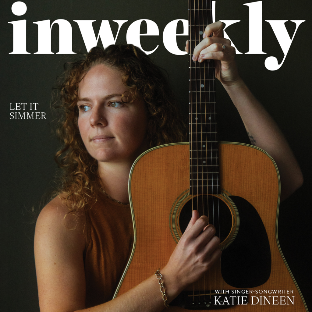 Portrait of a woman with curly hair holding an acoustic guitar, on a magazine cover with large 'weekly' text and 'Katie Dineen' featured