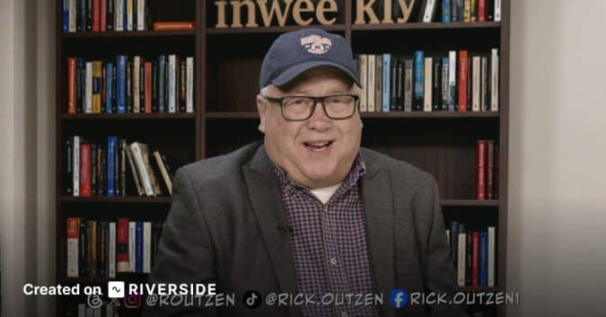 Smiling man in a blazer and cap speaks to the camera in front of a bookshelf backdrop; Riverside branding appears at the bottom left.